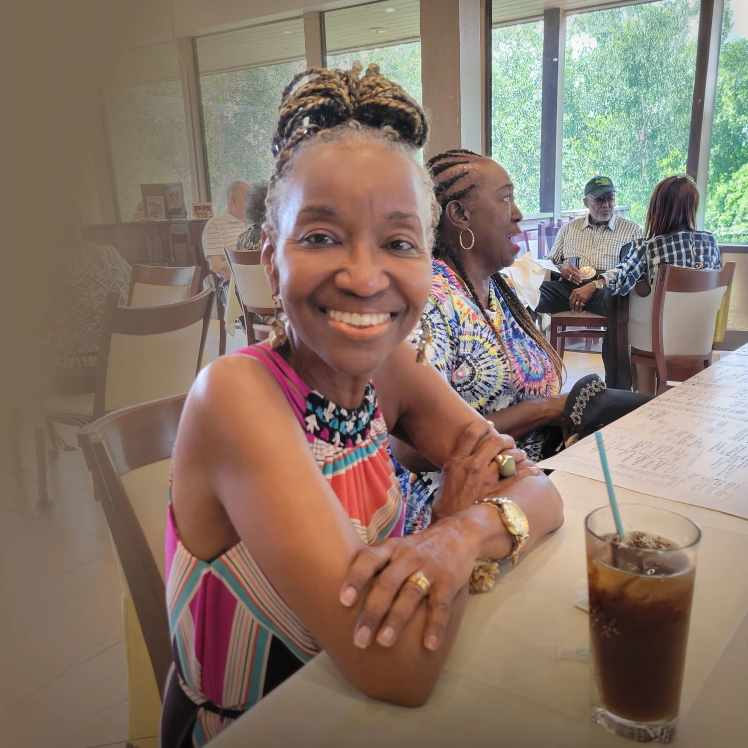 Alecia smiling at a restaurant table